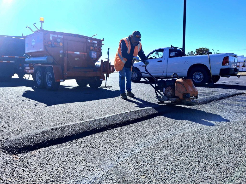 Crew compacting asphalt speed bump